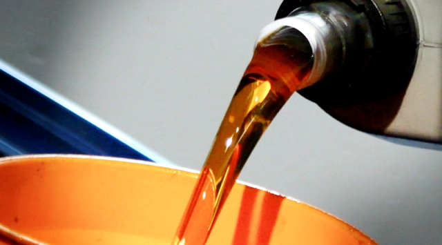 Motoröl Motoröl läuft aus Flasche in den Trichter für den Motor